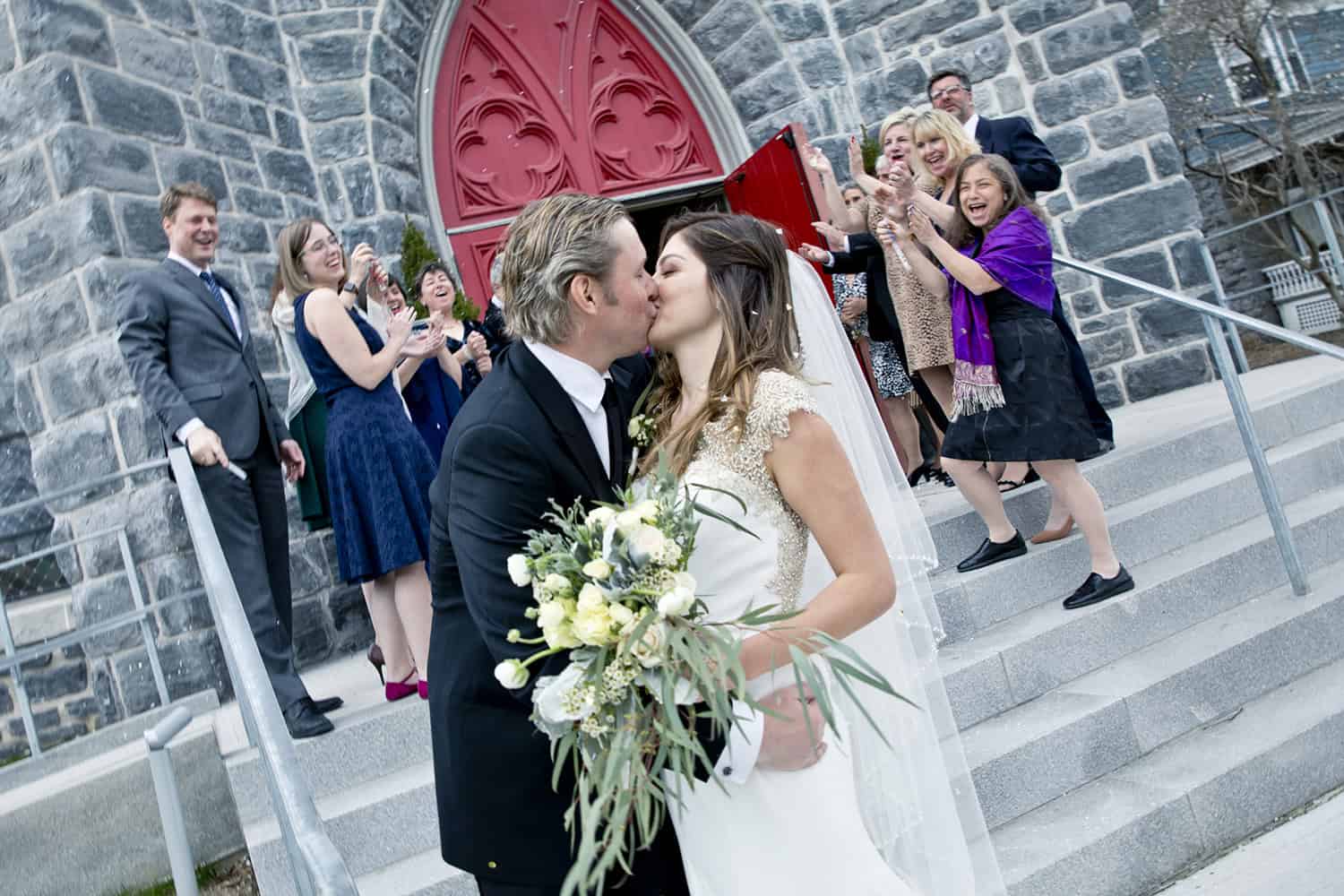 Bride and Groom kissing in front of Saint James Place