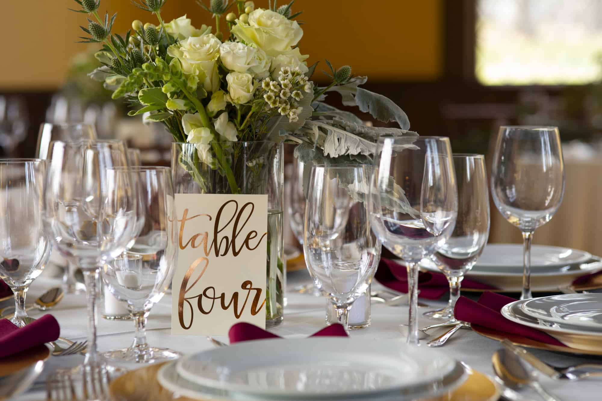 SJP wedding table setting with flowers and glasses