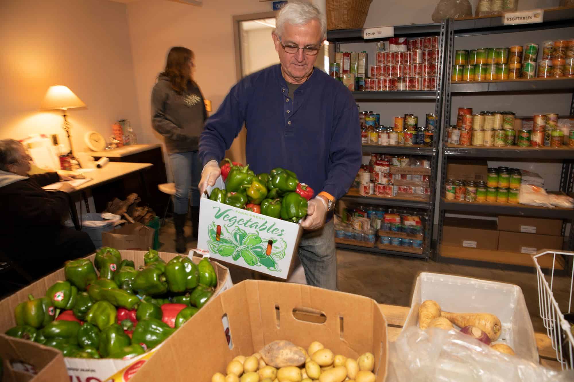 Volunteer sorting vegetables for The People's Pantry